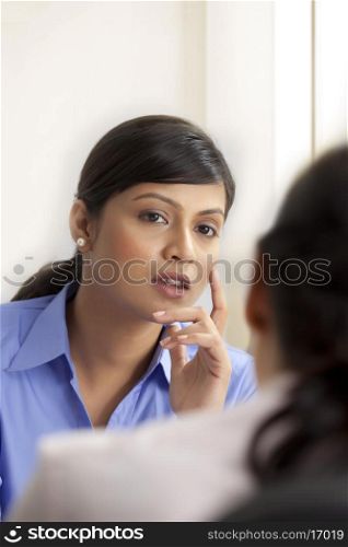 Businesswoman listening to other female executive
