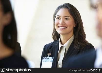 Businesswoman Listening To Speaker At Conference