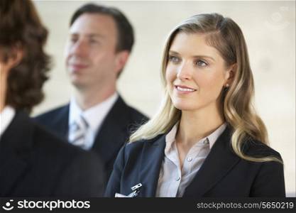 Businesswoman Listening To Speaker At Conference