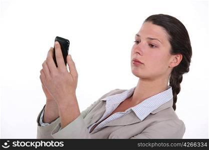 Businesswoman looking at her mobile phone