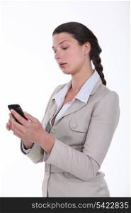 Businesswoman looking at her phone