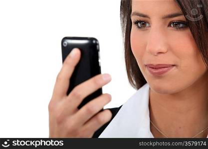 Businesswoman, looking at mobile telephone