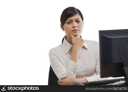 Businesswoman looking at monitor screen with concentration