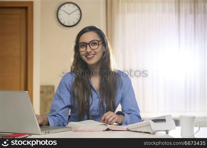 Businesswoman looking away at office desk