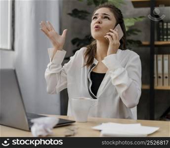 businesswoman looking frustrated while having call