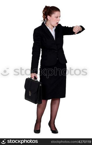 Businesswoman looking in shock at her watch