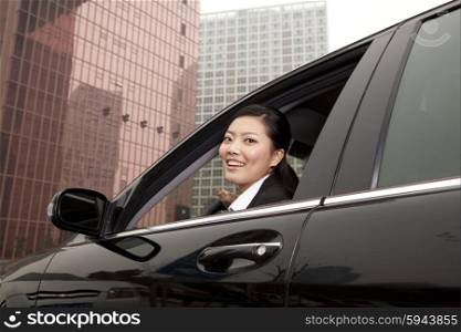 Businesswoman looking out car window