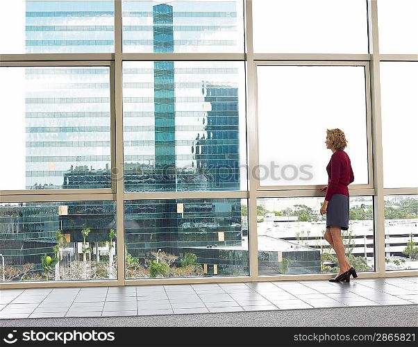 Businesswoman looking out of office window