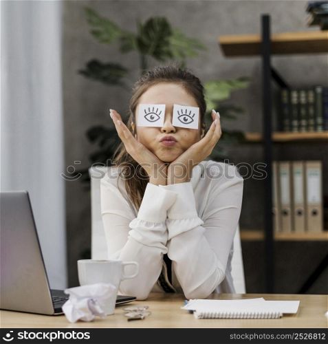 businesswoman looking silly with her eyes covered