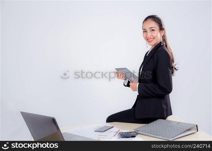 businesswoman looking tablet with sitting table in office on white background.