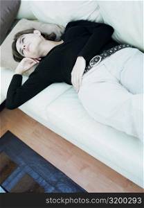 Businesswoman lying on a couch