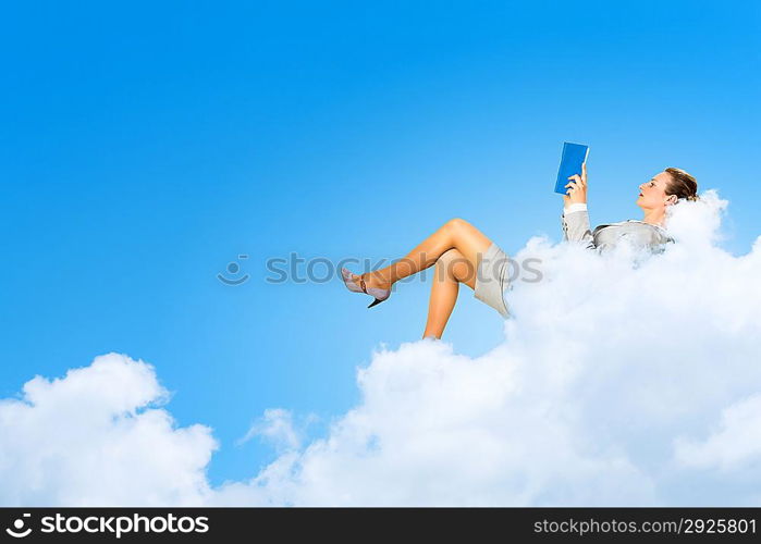 Businesswoman lying on clouds