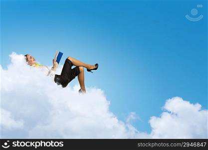 Businesswoman lying on clouds