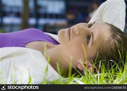 Businesswoman lying on grass in a park