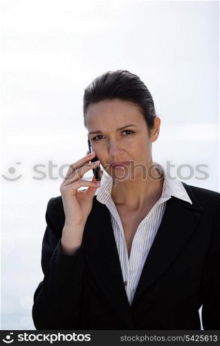 Businesswoman making a call from outdoors