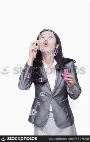 Businesswoman making bubbles