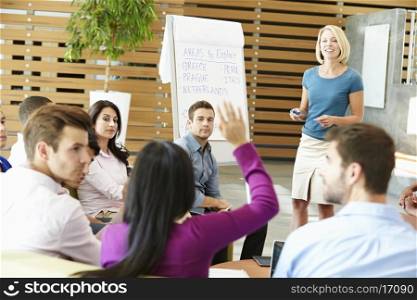 Businesswoman Making Presentation To Office Colleagues