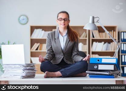 Businesswoman meditating in the office