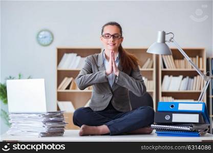 Businesswoman meditating in the office