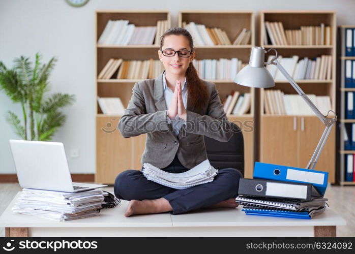 Businesswoman meditating in the office