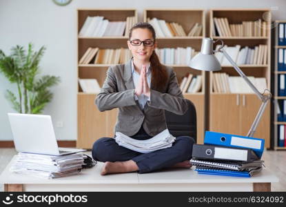 Businesswoman meditating in the office