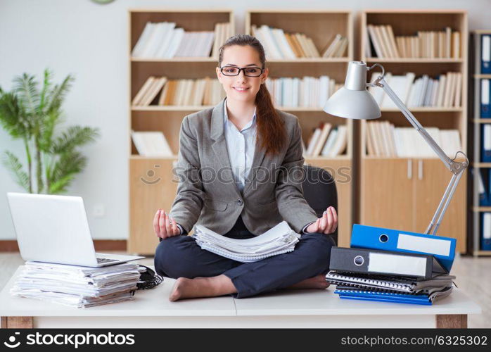 Businesswoman meditating in the office