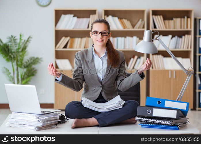 Businesswoman meditating in the office