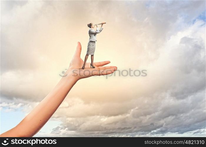 Businesswoman miniature in hand. Image of businesswoman miniature looking in telescope standing in hand