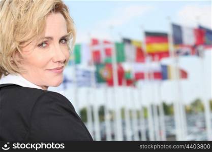 Businesswoman next to flags