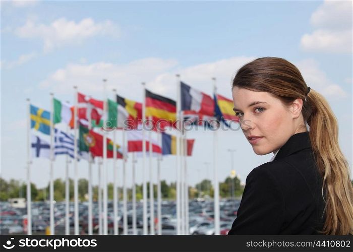 Businesswoman next to flags