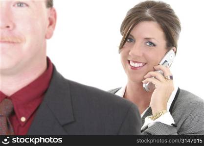 Businesswoman On Cellphone. Focus on woman. Man in foreground out of focus.