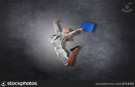 Businesswoman on cement background. Young businesswoman in jump over concrete background