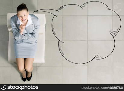 Businesswoman on chair. Top view of young businesswoman sitting on chair