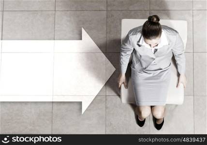 Businesswoman on chair. Top view of young businesswoman sitting on chair