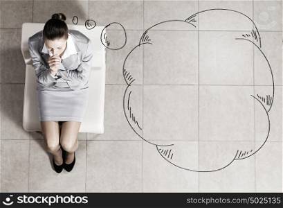 Businesswoman on chair. Top view of young businesswoman sitting on chair