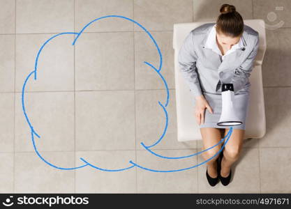 Businesswoman on chair. Top view of young businesswoman with megaphone sitting on chair