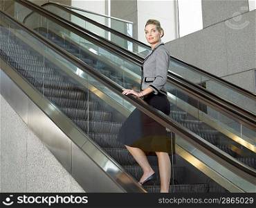 Businesswoman on escalator (portrait)