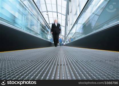 businesswoman on moving escalator