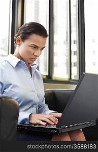 Businesswoman on Sofa Using Laptop