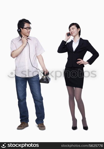 Businesswoman on the phone, man with stationary phone