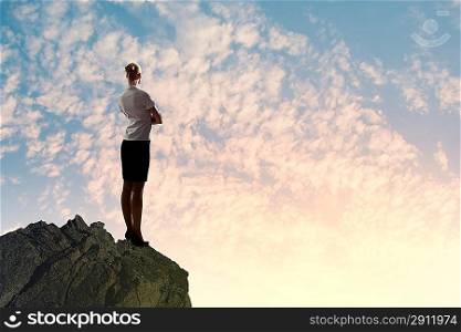 Businesswoman on top of hill
