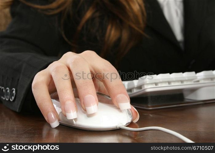 Businesswoman operating a computer mouse