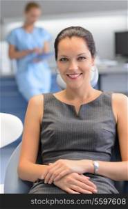 Businesswoman patient sitting chair at dental surgery teeth checkup