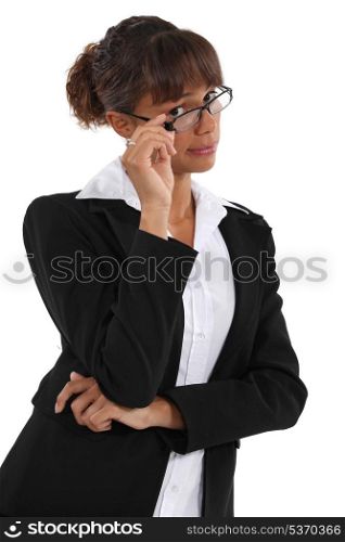Businesswoman peering over her glasses