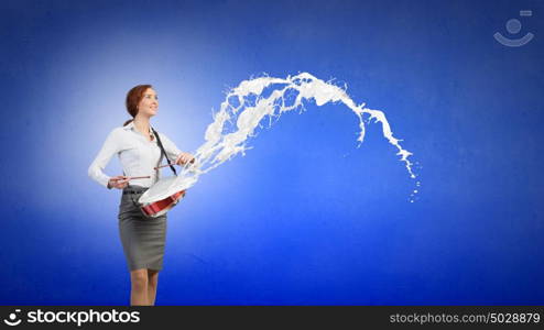 Businesswoman playing drums. Young businesswoman playing drums and white splashes of paint