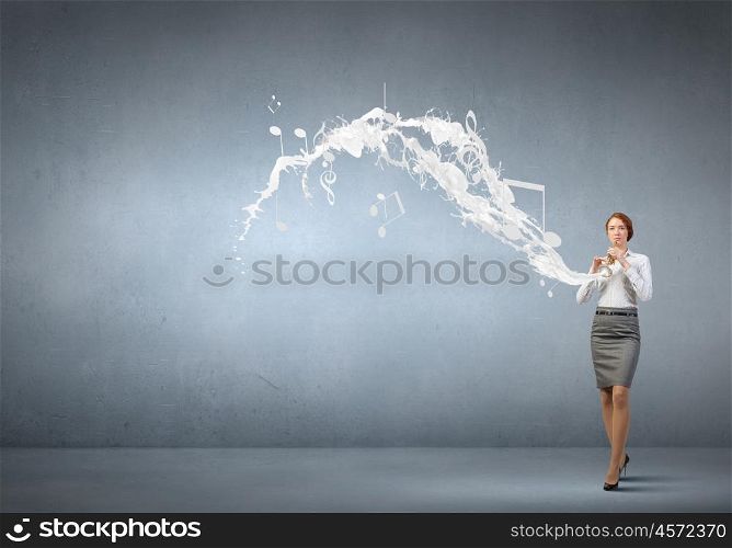 Businesswoman playing fife. Cheerful businesswoman playing fife on color background