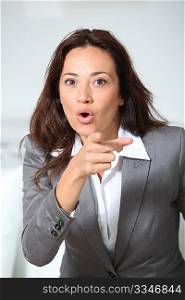 Businesswoman pointing at camera