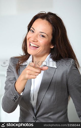 Businesswoman pointing at camera