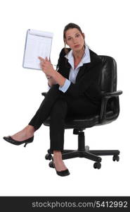 businesswoman pointing at notepad