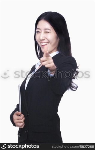 Businesswoman pointing finger like gun